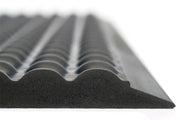 Dark rubber bubble mat surface with raised oval studs, close-up edge