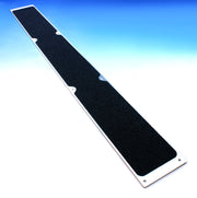 Aluminum bolt-down stair tread plate with black non-slip surface and mounting holes