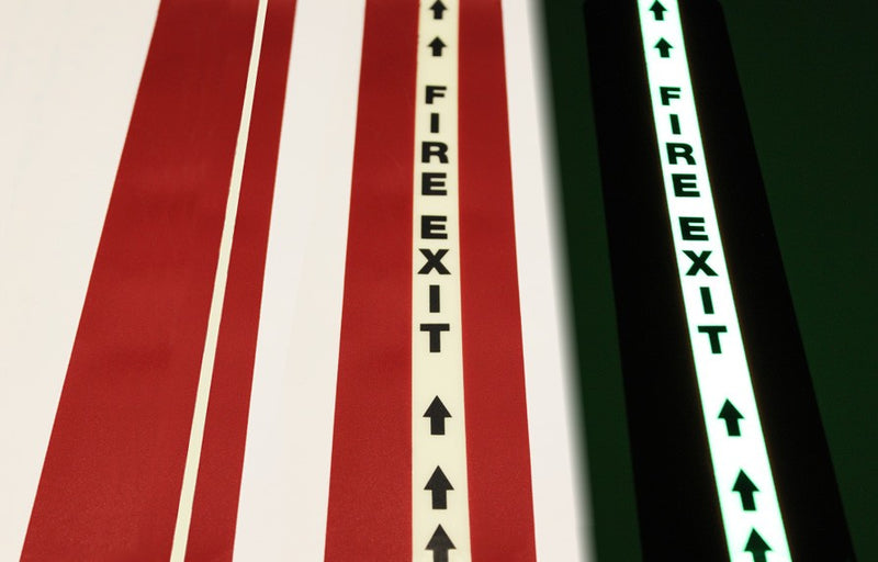 Red glow floor tape, 10cm wide with white fire-exit arrows and 2.5cm glow stripe