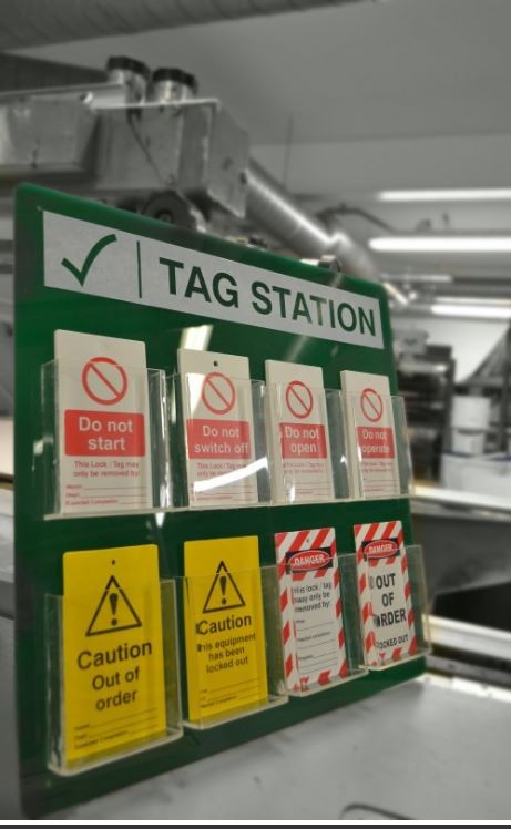 Green tag station panel with clear label holders and warning stickers