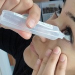 Sterile eyewash pods in clear blister, held by hands
