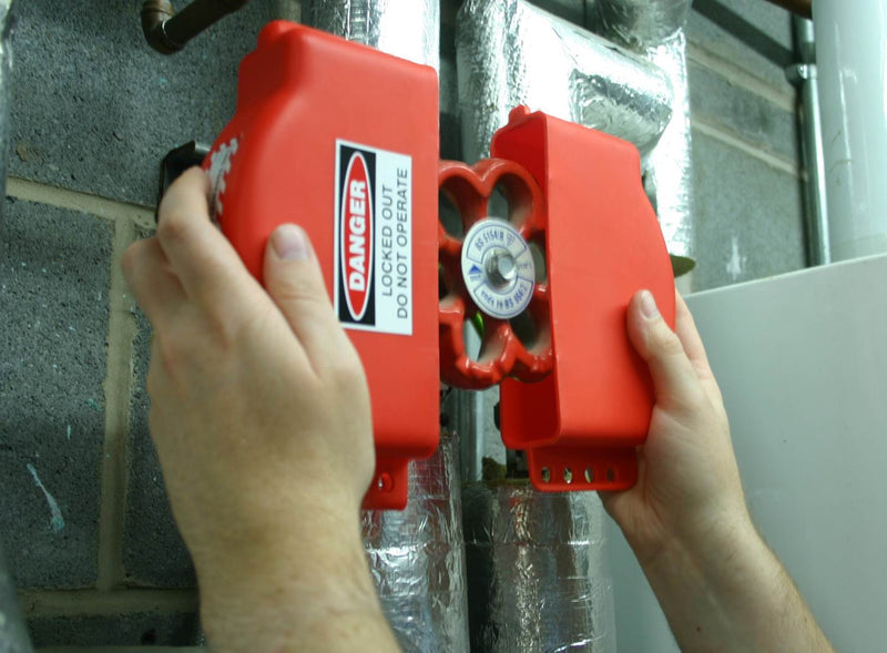 Red gate valve lockout with clamp and handwheel, attached to valve