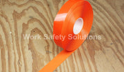 Orange safety floor tape roll with an orange tape strip extending on the floor
