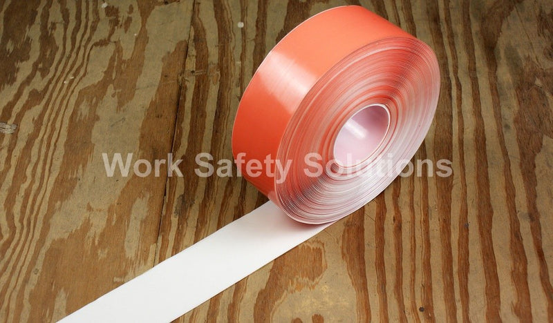 White safety floor tape roll with a white tape strip extending on the floor