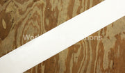 White safety floor tape strip extending across the floor