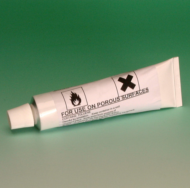 White squeeze tube sealant for porous surfaces, with cap and printed label.